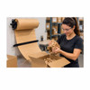Warehouse worker using kraft paper from EP-5905 wall-mounted dispenser as protective void fill in a shipping box