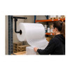 Worker dispensing bubble wrap from Encore EP-6000S Wall-Mount Bubble Wrap & Foam Roll Dispenser at a warehouse packing station
