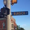 Stainless steel banding securing a street sign to a metal pole