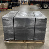 Plastic coil separators positioned under strapping on a stretch-wrapped pallet load