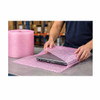 Worker wrapping a laptop with pink 3/16" anti-static air bubble wrap for shipping protection