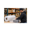 Warehouse worker using 1/2" heavy-duty air bubble roll to wrap a product for shipping