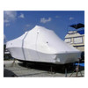Large boat covered with white marine shrink wrap for outdoor storage and winterization