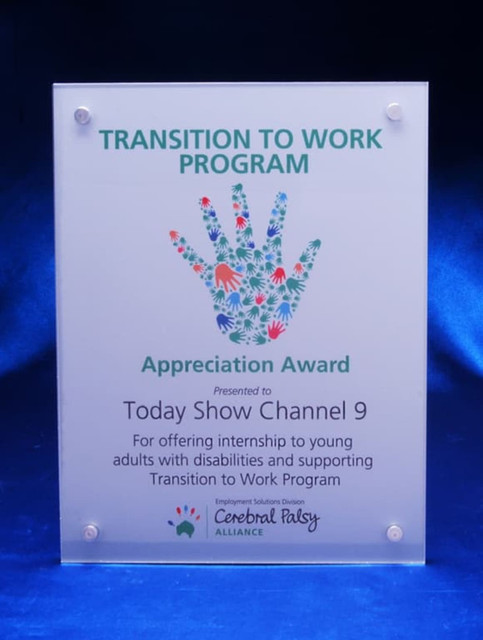 A clear acrylic award plaque featuring a handprint design, presented as an appreciation award. A clear acrylic award plaque featuring a handprint design, presented as an appreciation award.