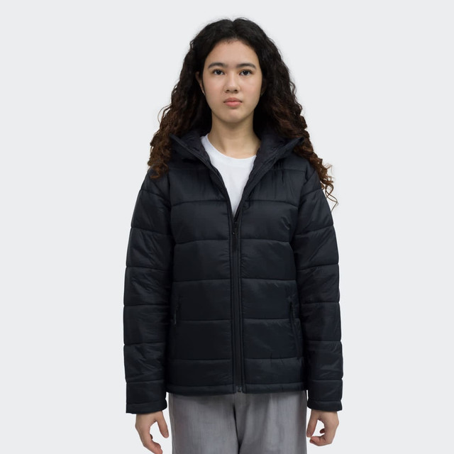 A black puffer jacket with a zip front and a hood, worn by a model with curly hair. The jacket features a logo.