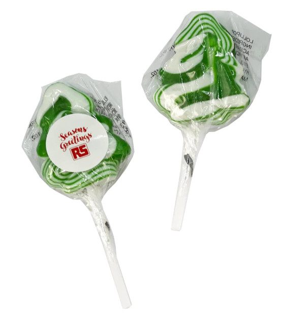 Two green and white Christmas tree-shaped lollipops on transparent sticks, featuring a branded label.