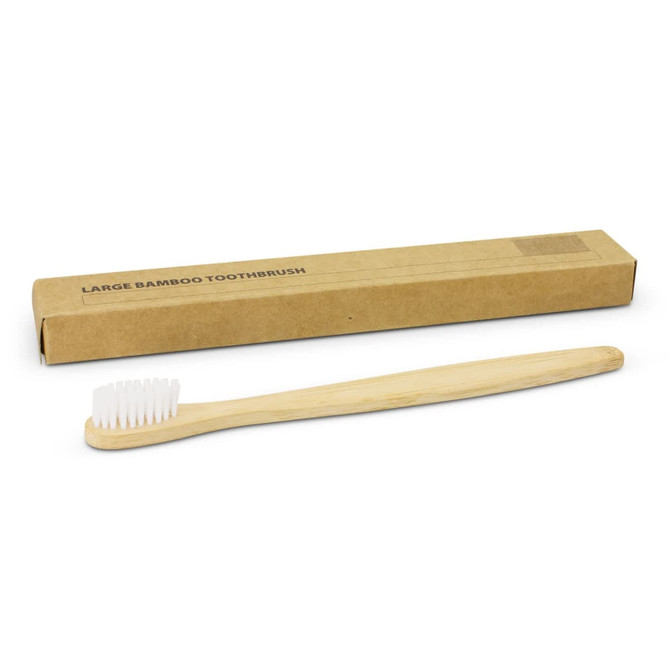 A bamboo toothbrush in natural colour, alongside a recyclable cardboard box. The toothbrush has white bristles.