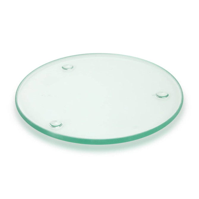 A round, transparent glass coaster with three small feet for stability.