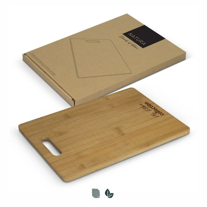 A bamboo rectangle chopping board with a handle, presented on a brown cardboard package.