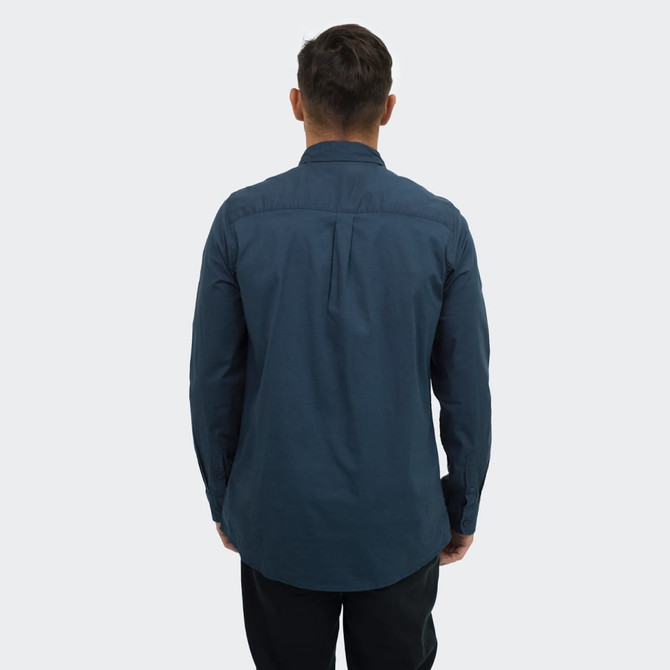 A men's poplin button-up shirt in navy blue, featuring a back pleat and long sleeves. Includes a logo.