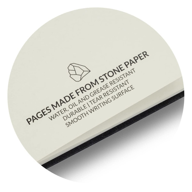 A notebook with cream pages made from stone paper, featuring a black spine and a logo.