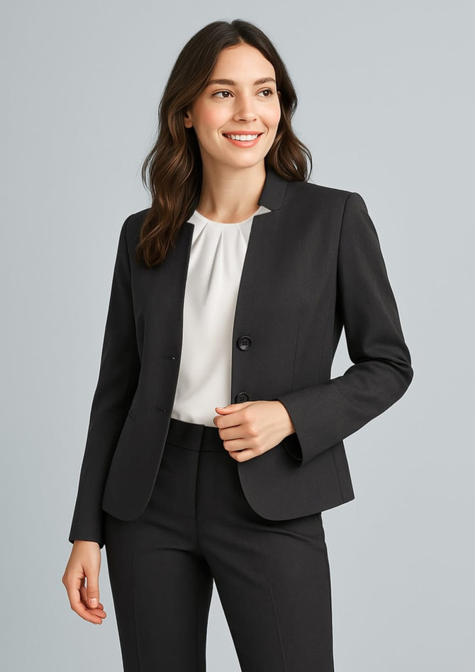 A black women's cool stretch short jacket with reverse lapel, styled with a white top and black trousers.