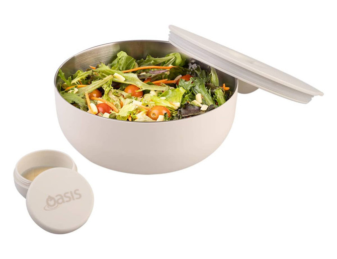 A bowl in cream colour with a salad inside, accompanied by a small container, featuring a logo.
