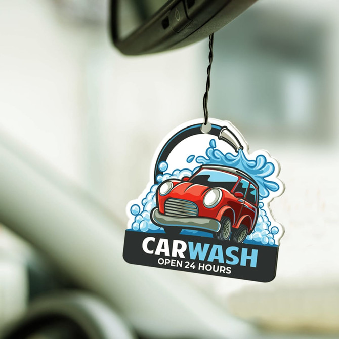 A car air freshener featuring a red car with a water splash and the text "CAR WASH OPEN 24 HOURS."