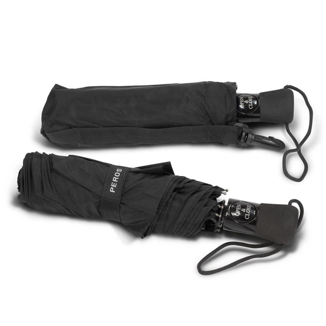 A black Metropolitan umbrella folded and partially opened, featuring a handle and carrying strap.