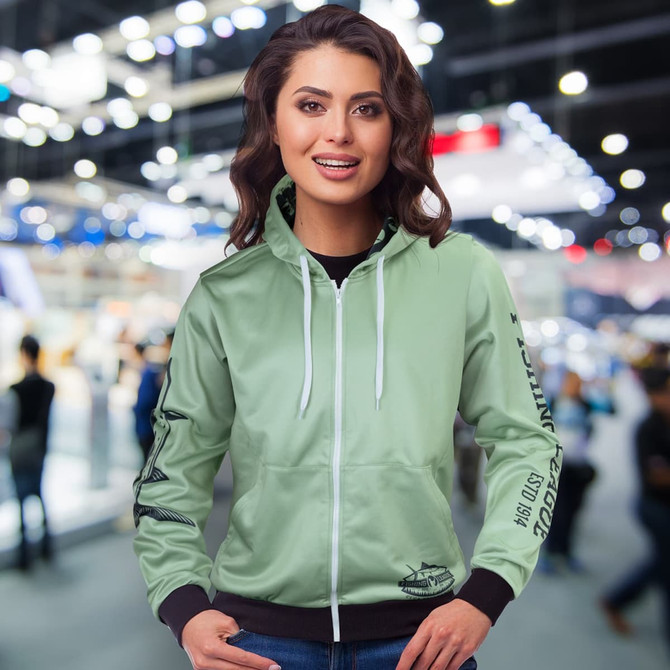 A light green women's zipped hoodie with a hood and a logo, featuring long sleeves and a fitted design.