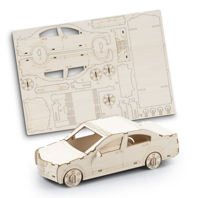 A wooden model car kit with unassembled parts displayed on a flat sheet. The model is light beige in colour.
