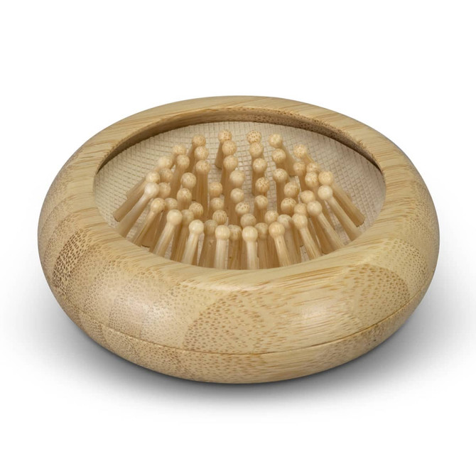 A bamboo brush with a rounded base and numerous bristles, accompanied by a mirror, showcasing natural tones.