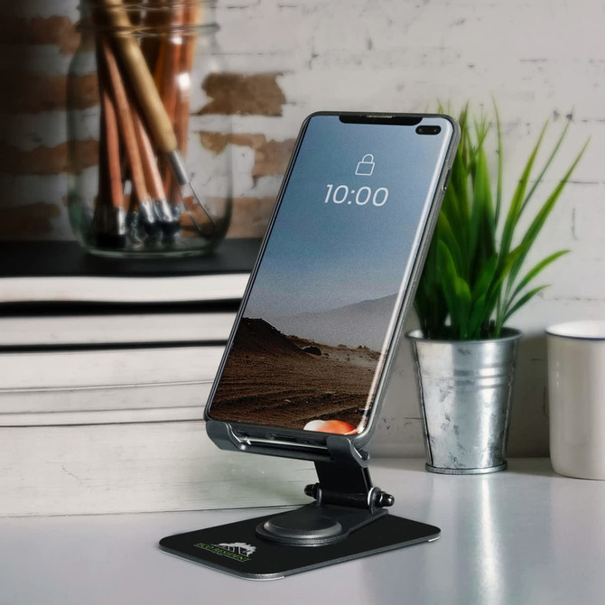 A silver metal phone and tablet stand with a black base, holding a smartphone against a minimalistic background.