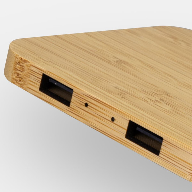 A bamboo wireless charging hub with a sleek design featuring multiple ports on one side.