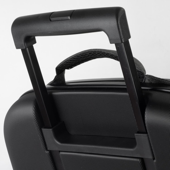 A close-up of a black wheeled suitcase handle, featuring a textured surface and a retractable mechanism.