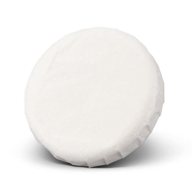 A round, white soap wrapped in paper, featuring a plain surface and a smooth texture.
