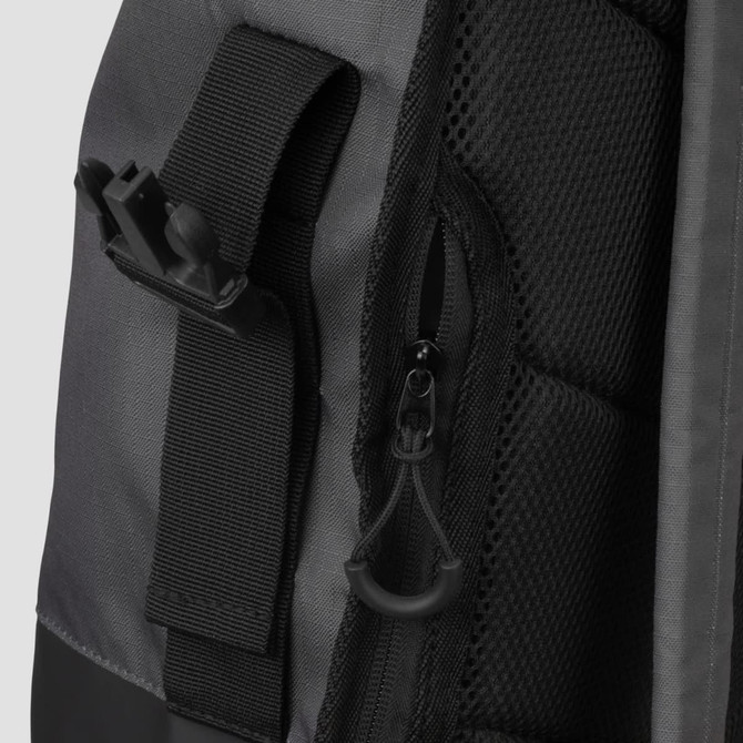 A grey and black Fjord Backpack features zippers and adjustable straps, with various textured materials.