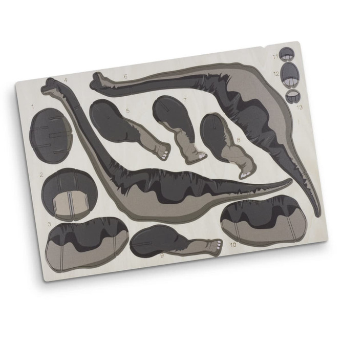 A wooden puzzle kit featuring Brachiosaurus parts in black and grey, neatly arranged on a light wood base with a logo.