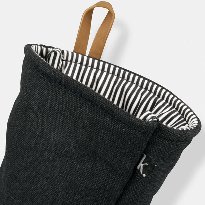 A dark grey oven mitt with a striped interior and a leather loop for hanging. It features a small logo.