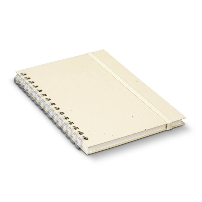 A beige recycled paper spiral notebook with an elastic band and a silver spiral binding.