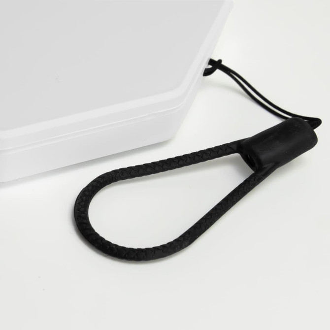 A foldable lantern in white with a black carrying strap attached. The design includes a compact, rectangular shape.