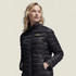 A woman wearing a black puffer jacket with a logo on the chest, featuring a high collar and zippered front.
