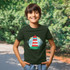 A youth t-shirt in dark green featuring a lighthouse design, set against a natural outdoor background.