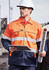 A man wearing a high-visibility orange and navy jacket, holding a notebook and rolled plans, with a hard hat on.