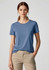 A women's short sleeve tee in blue, made from a smooth fabric, paired with light-coloured pants. The shirt features a logo.