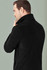 A black micro fleece jacket featuring a collar, shown from the back, with a logo on the sleeve.