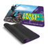 A vibrant mouse mat featuring a scenic travel image, with a textured black underside and a logo.