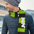 A knitted scarf in green and black with a logo, worn by a man in a grey beanie and a textured sweater.