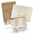 A wooden model of a cow in natural wood tones, accompanied by packaging with cut-out designs.