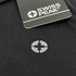 A black polo shirt featuring a subtle logo, with a tag indicating the brand Swiss Peak.