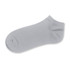 A grey ankle sock with a soft texture and a logo on the side.