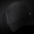 A black Swiss Peak 5 Panel Cap featuring a logo, displayed against a dark background.