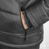 A black puffer jacket featuring a zippered pocket and cuffed sleeves. The hand is visible in the pocket.