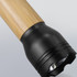 A bamboo torch with a black head, featuring a sleek design and a powerful light source.