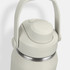 A drink bottle in a light grey colour with a stainless steel body and a secure lid featuring a handle.