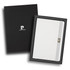 A white notebook in a black gift box, featuring a branding logo and a closure strap.