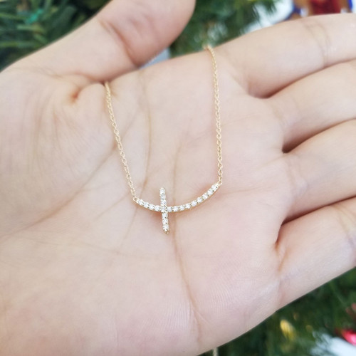 sideways curved diamond cross necklace