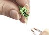 Sensio JB4 2-pin connector with stripped cable ends ready for insertion during LED lighting installation.