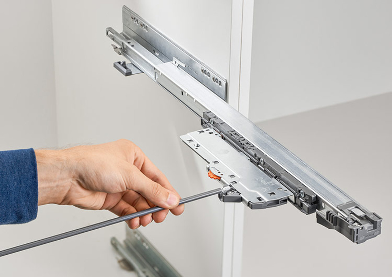 Fitting the cut to size synchronisation rod into TIP-ON BLUMOTION Latch for wide drawer push-to-open operation Fitting the cut to size synchronisation rod into TIP-ON BLUMOTION Latch for wide drawer push-to-open operation