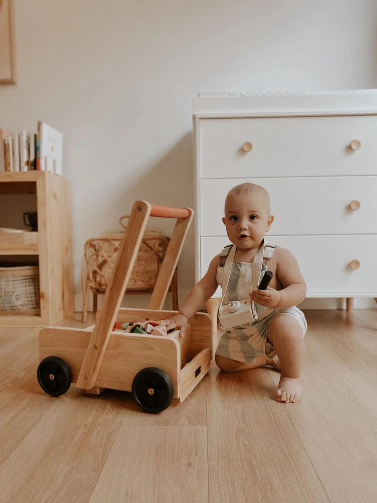 playing with wooden wagon